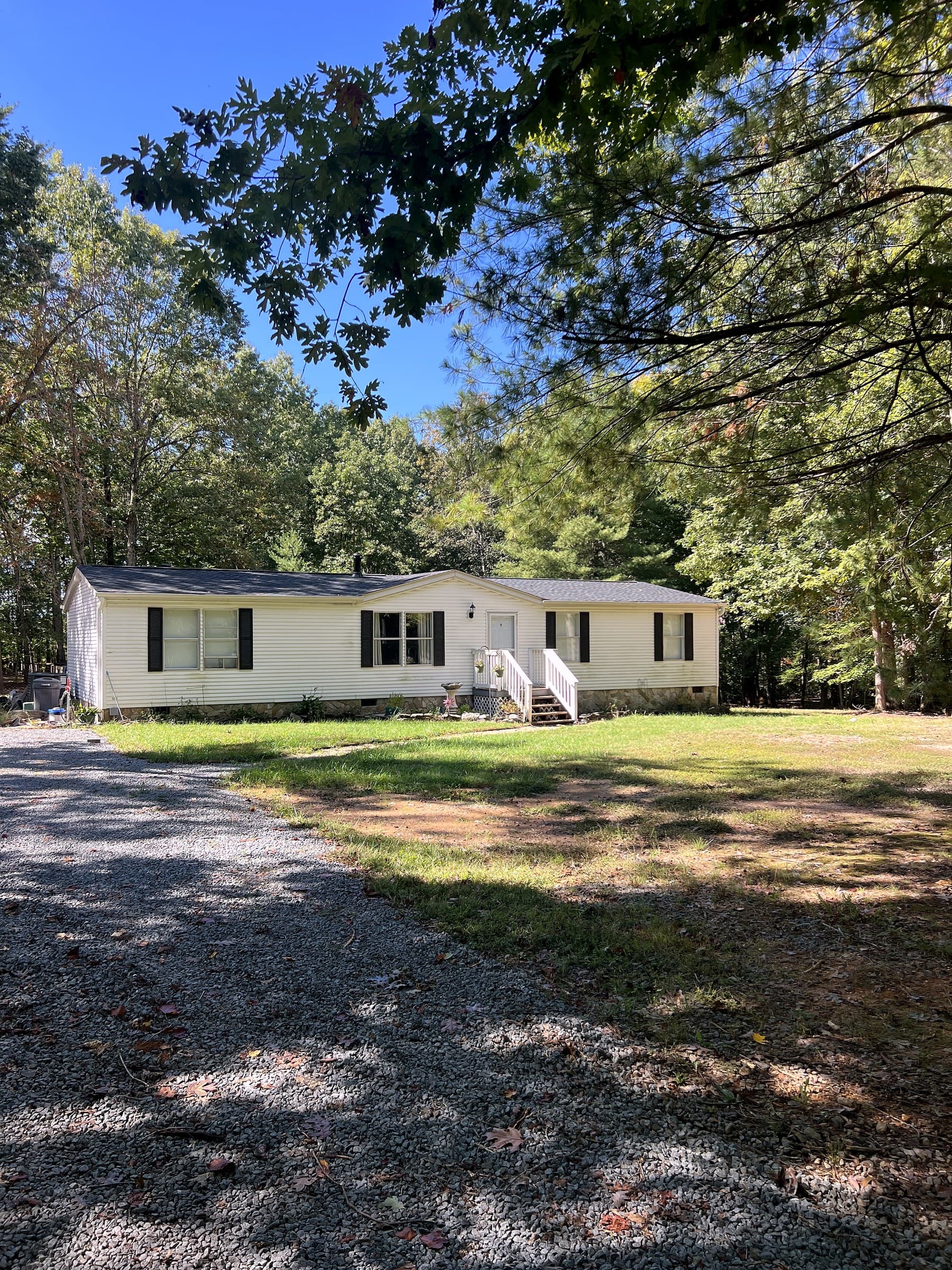 Ranch home in Rhoadesville, VA with a new GAF Timberline HDZ Charcoal roof, a brick foundation, and a concrete walk to the front door
